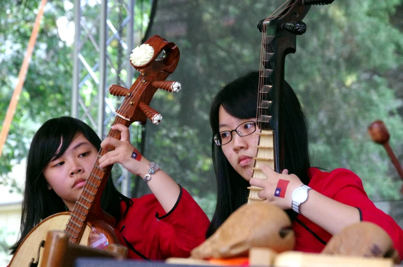 two women playing an instrument in a band