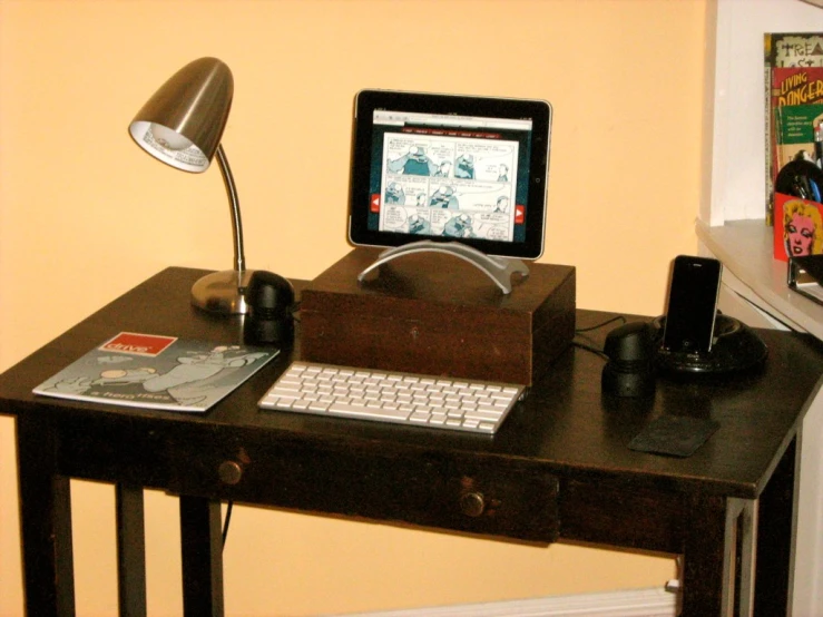 a laptop on a desk in front of a computer