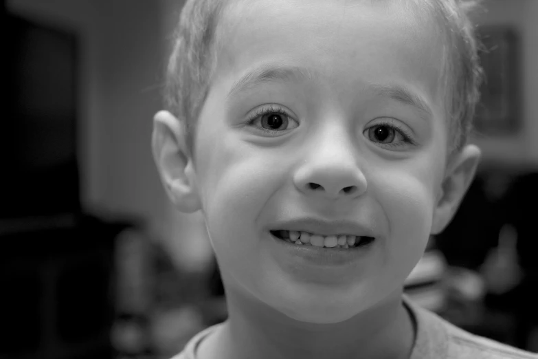 a smiling little boy with a shirt on