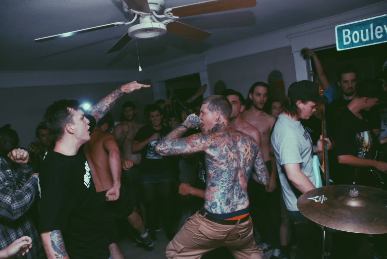 a man with a tattoo dancing on the dance floor