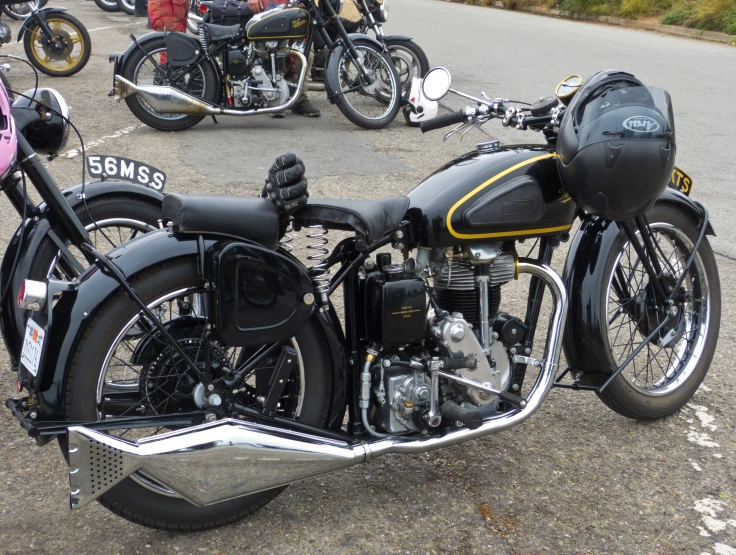 a motorcycle parked next to other motorcycles on the street