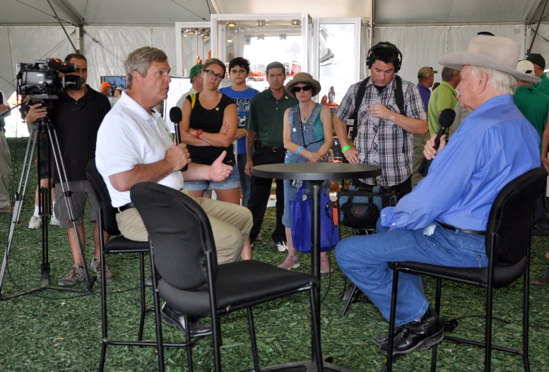 a large group of people standing and sitting around