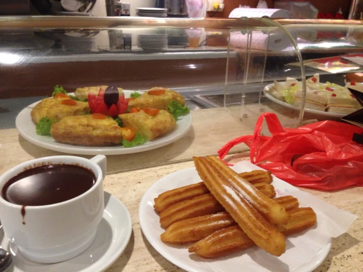 some food on plates and cups on a table