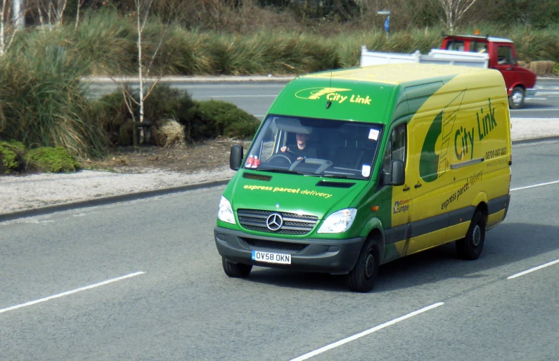 a delivery truck is traveling down the road