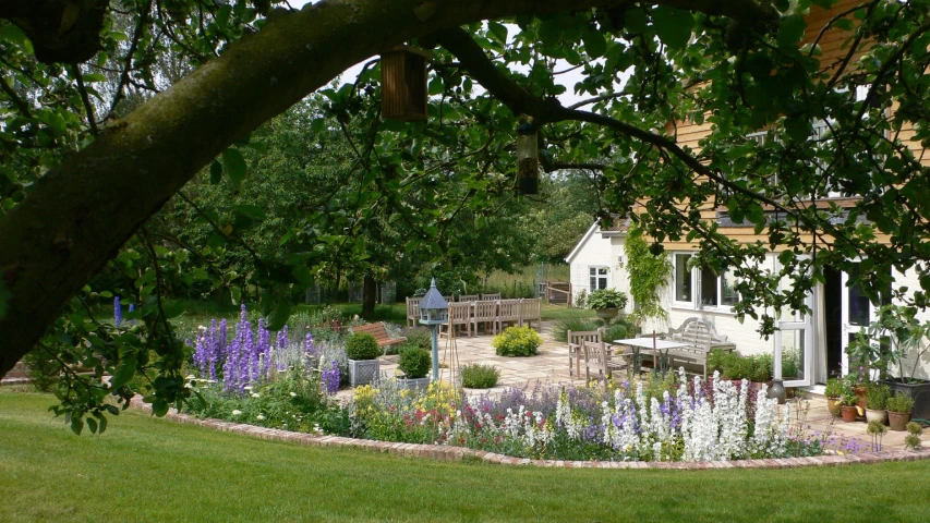 large garden area with flowers and trees surrounding it