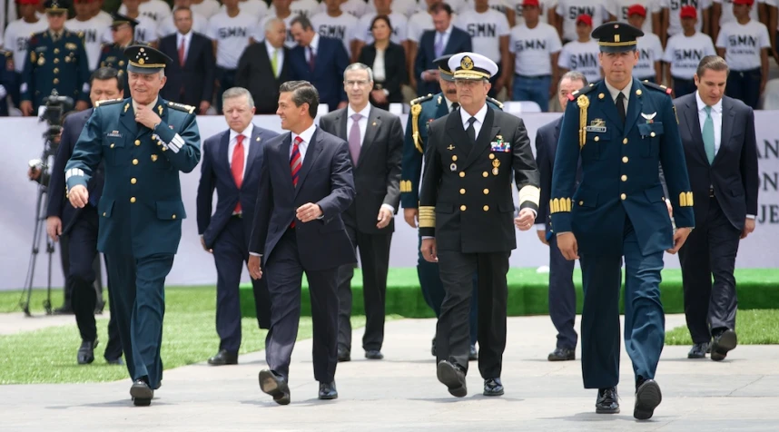 three men in uniforms are walking along