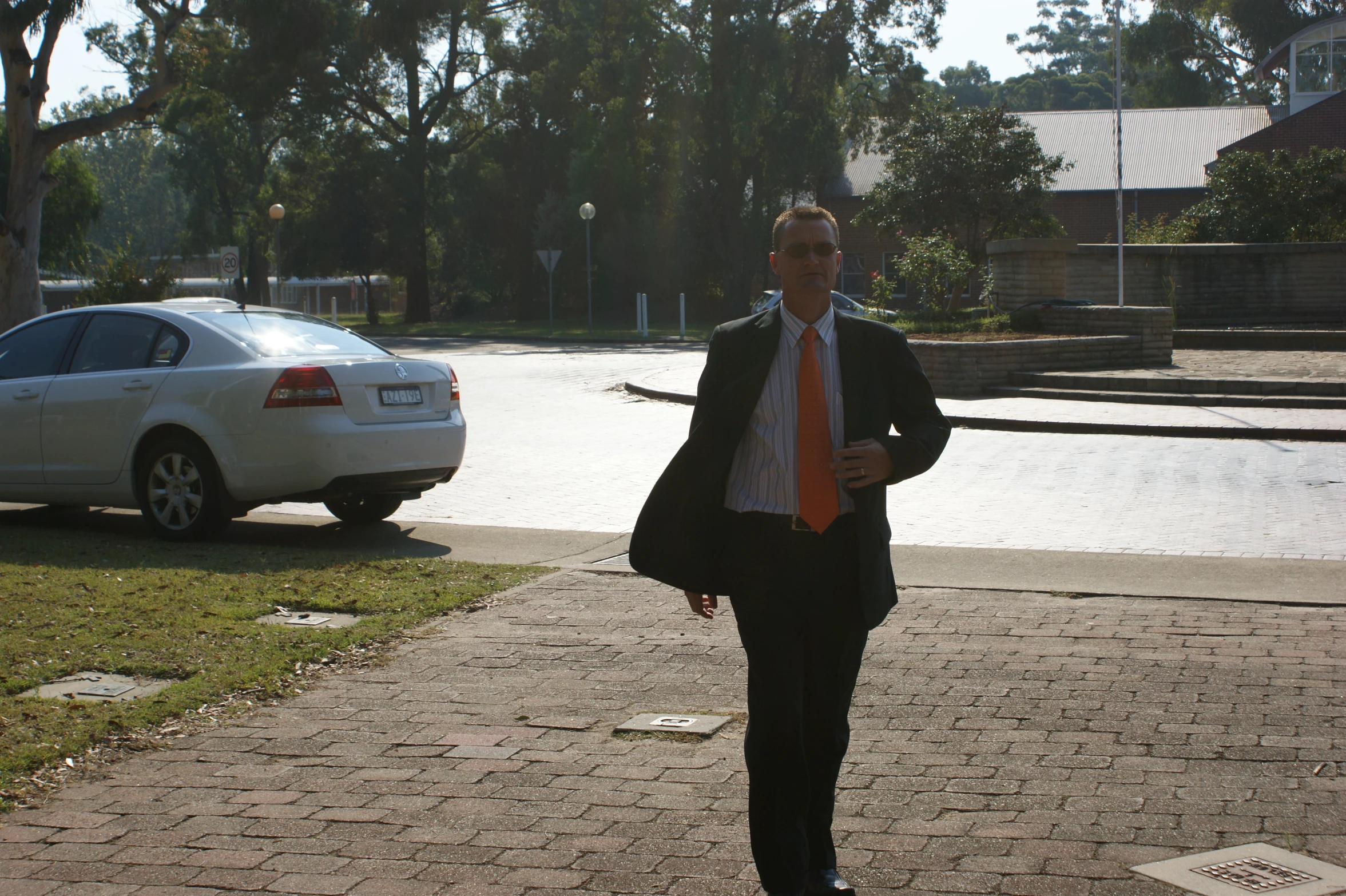 a man in a business suit standing in the street