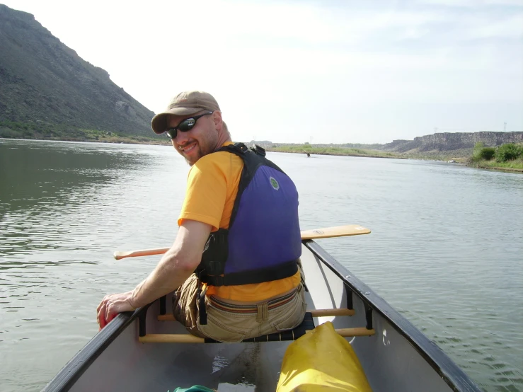 a man with shades and sunglasses in a blue boat