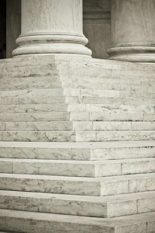 there are several white marble steps that have pillars above them