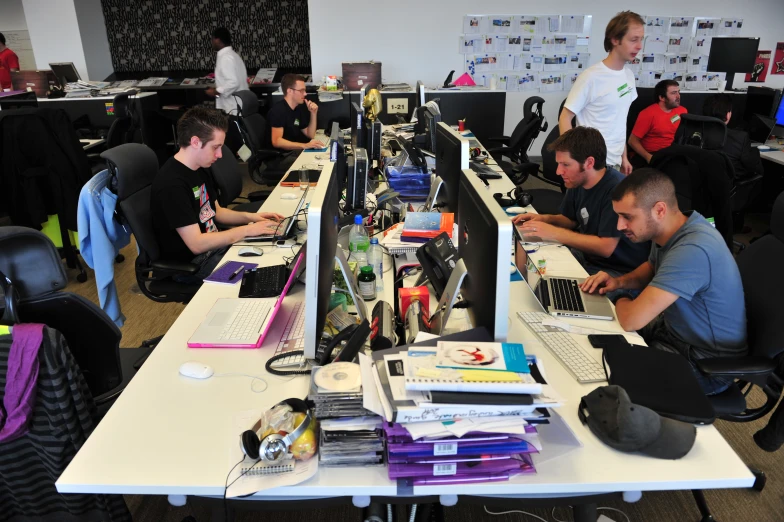 several students in a liry typing on their laptops