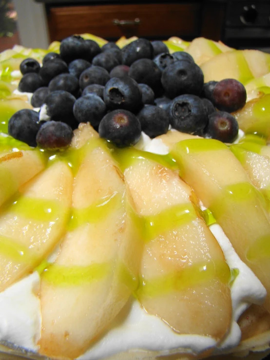 a fruit tart covered in blueberries and other fruits