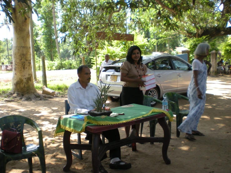 two people having a conversation in the shade