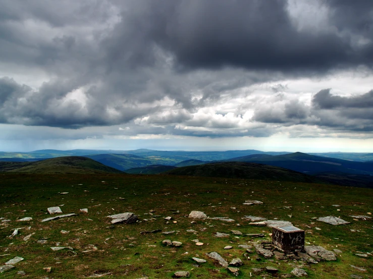 a scenic mountain view shows rocks and vegetation in the foreground