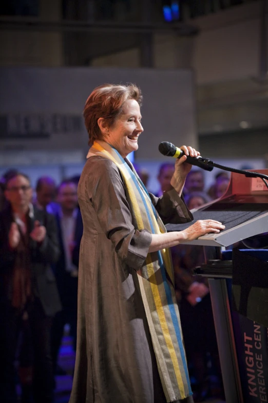 a woman with her hand up to a microphone