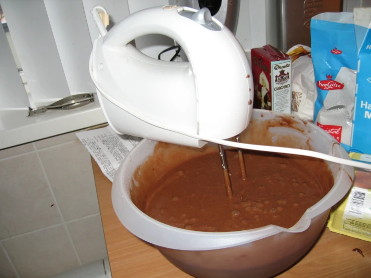 a mixer with soing brown and red in it