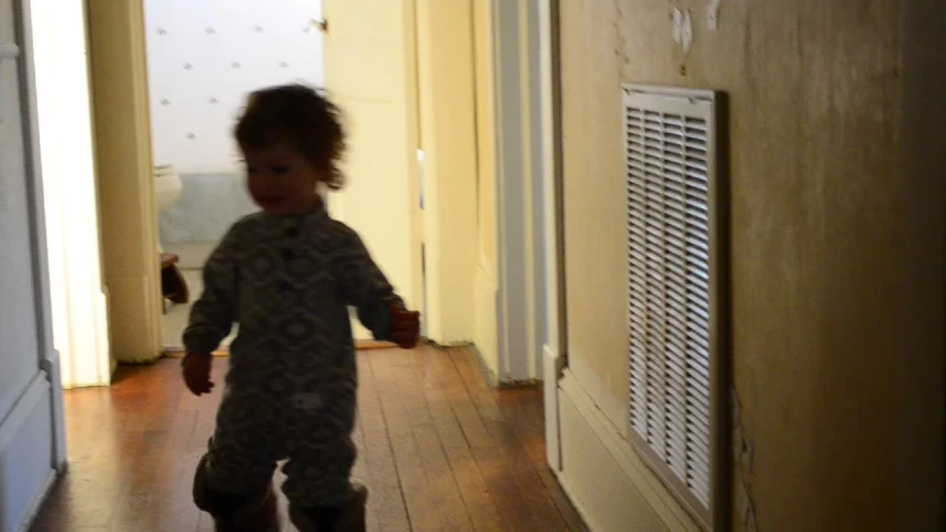 a young child dressed in military camo walks down an alley way