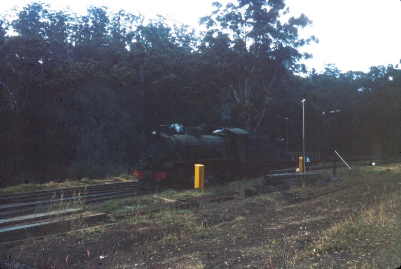 some kind of locomotive going along the tracks in the dark