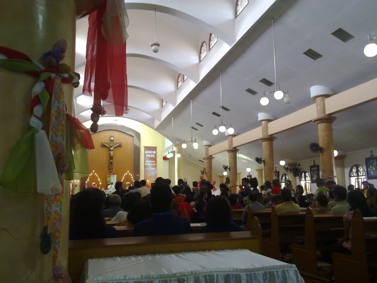 a large crowd of people in the alter of an older style church