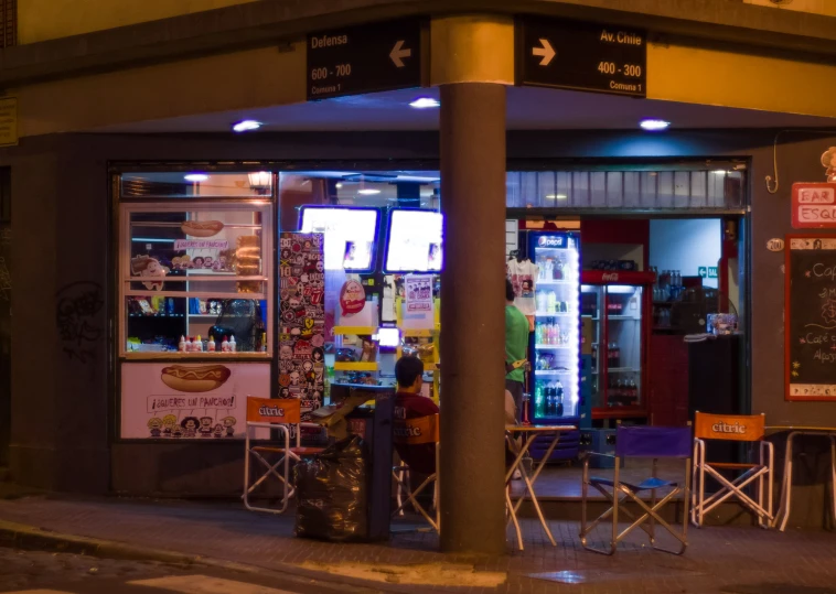 a person standing outside a food store with the door open