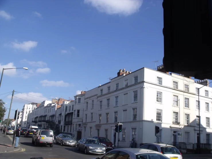 a street with several cars parked along it and buildings on the sides