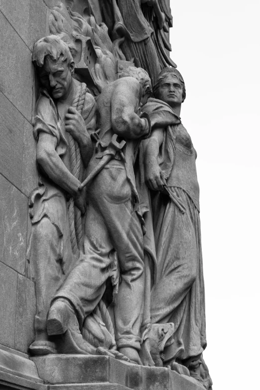 a statue is standing next to the wall