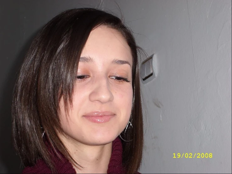 a woman looks up to her left side while wearing her nose piercing