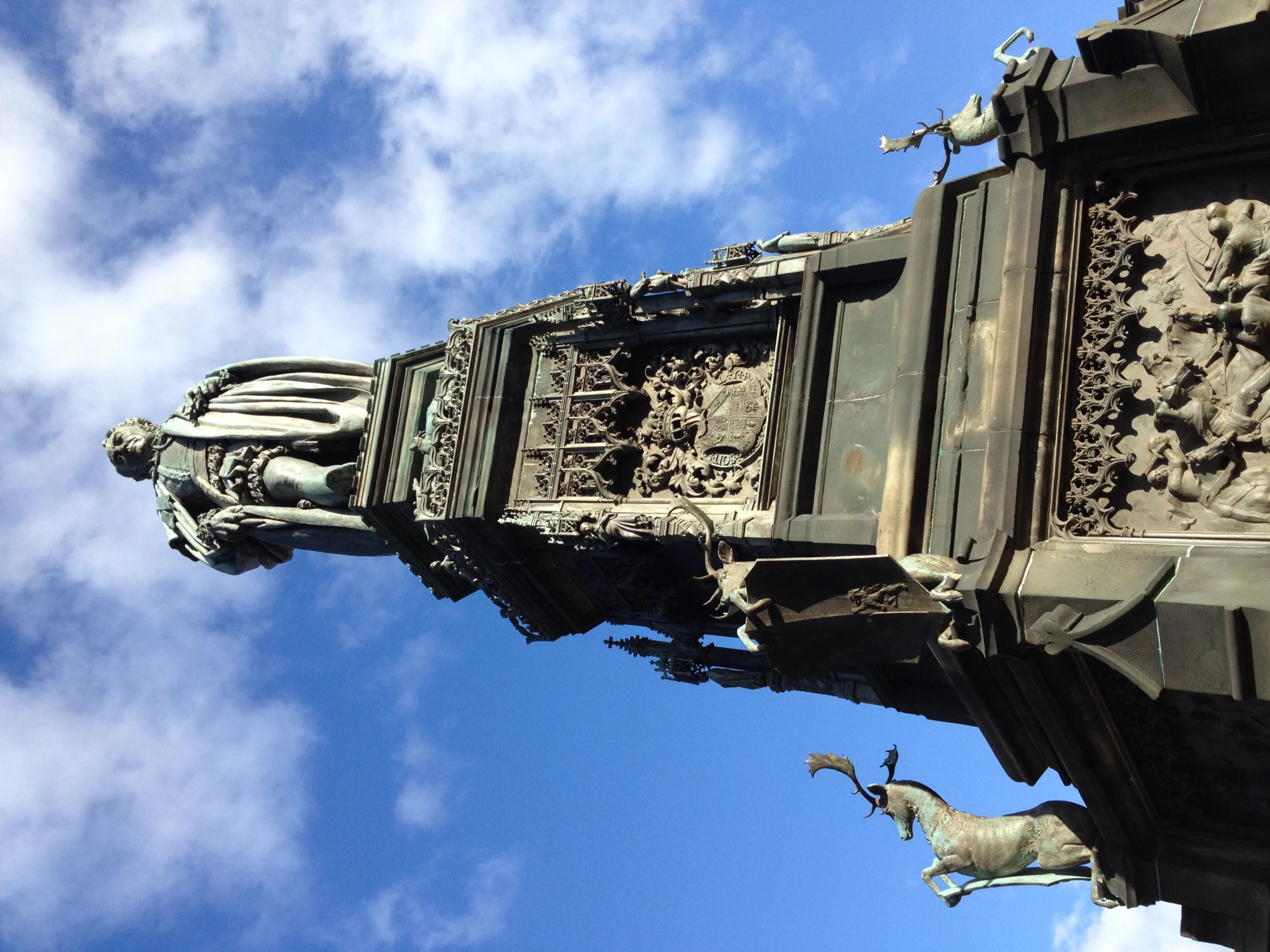 a statue sitting on top of a tall clock tower