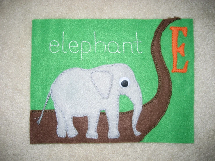 a towel with a white elephant and the words elephants on it