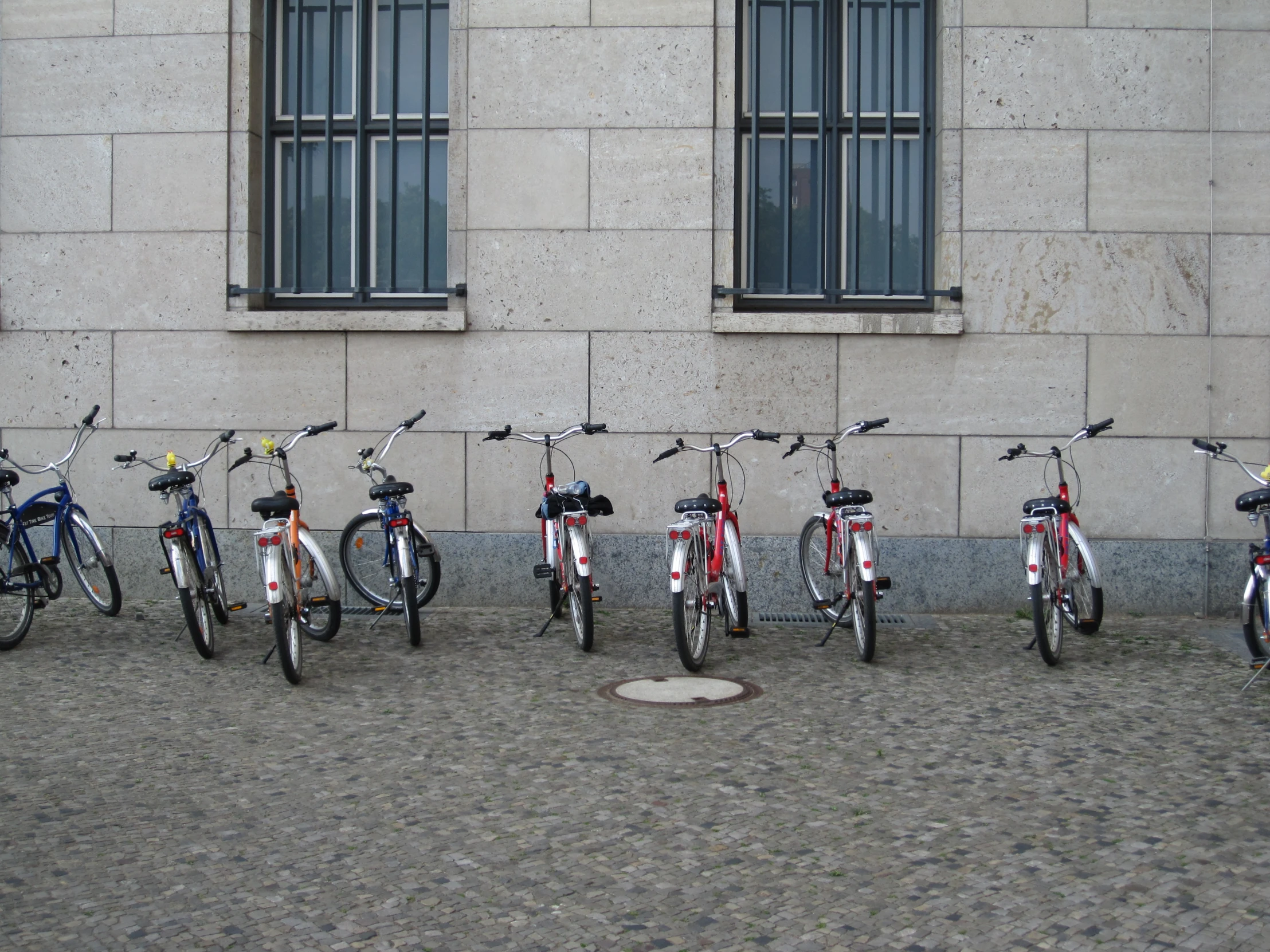 several bikes lined up in front of a building