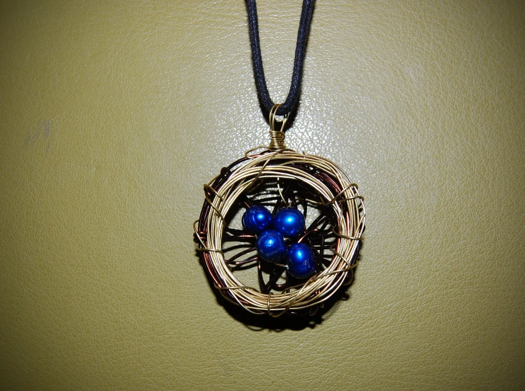 a wire wrapped circle with two blue stones