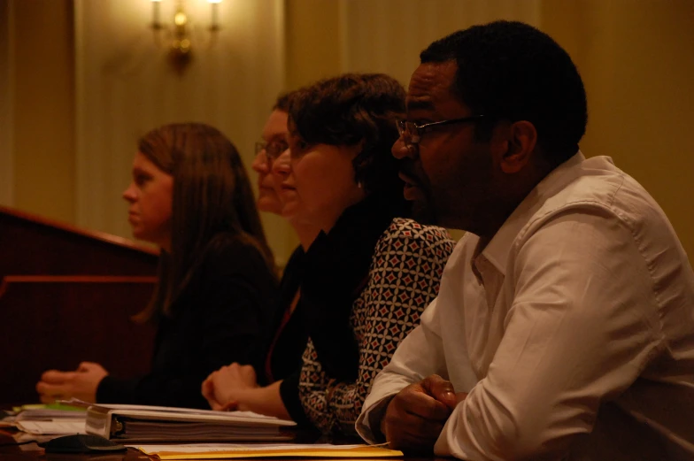 some people at a table with folders in front of them