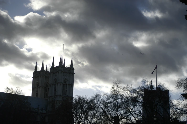 a clock tower with some clouds in the sky