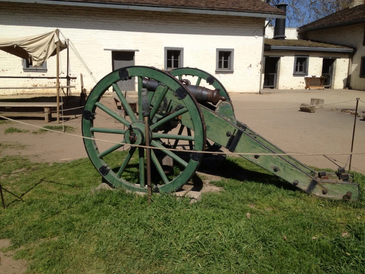 an old wooden cannon with a wagon on the back