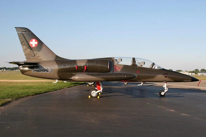 a fighter jet sitting on top of an airport runway