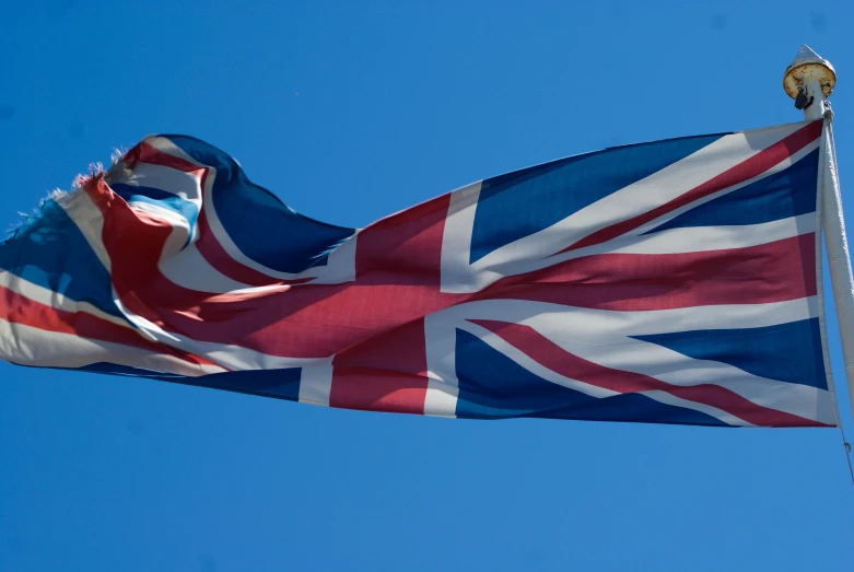 a red, white and blue flag flying in the wind