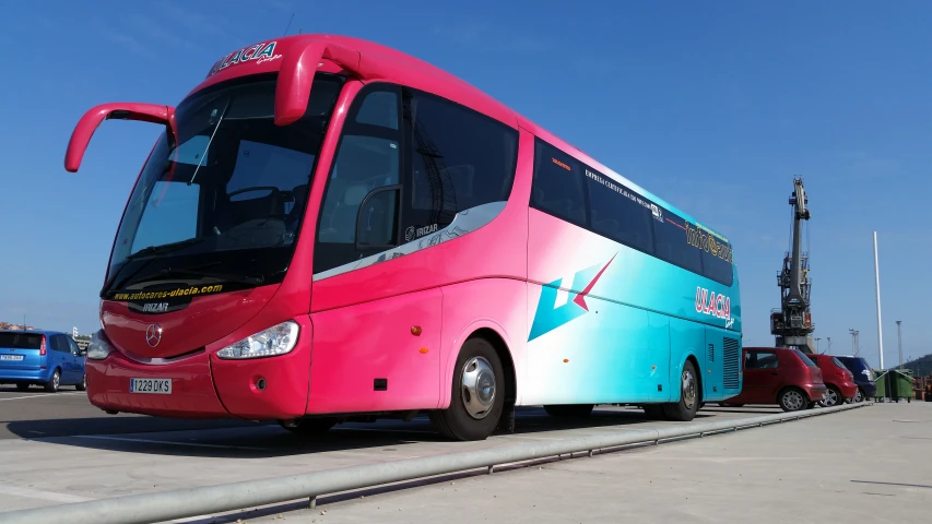 an odd looking bus that looks like it's painted pink and blue