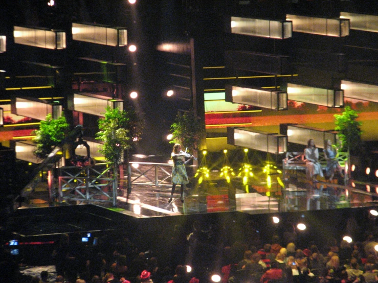 two men on a stage with lights and spectators