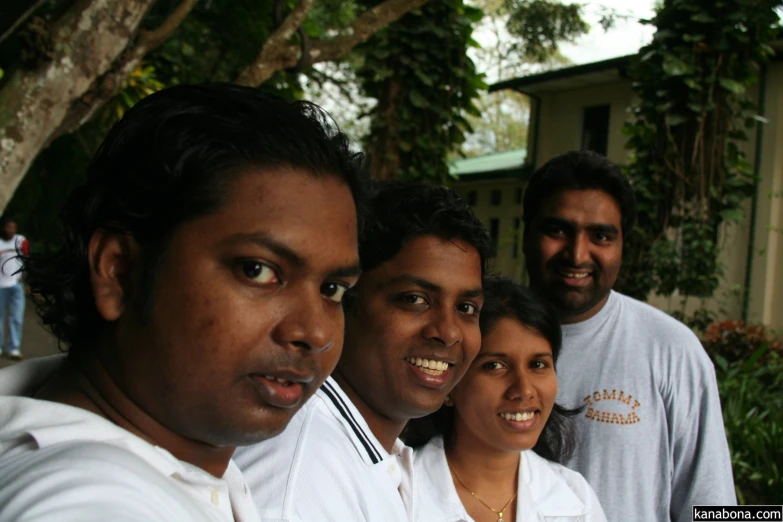 four people with their arms around each other