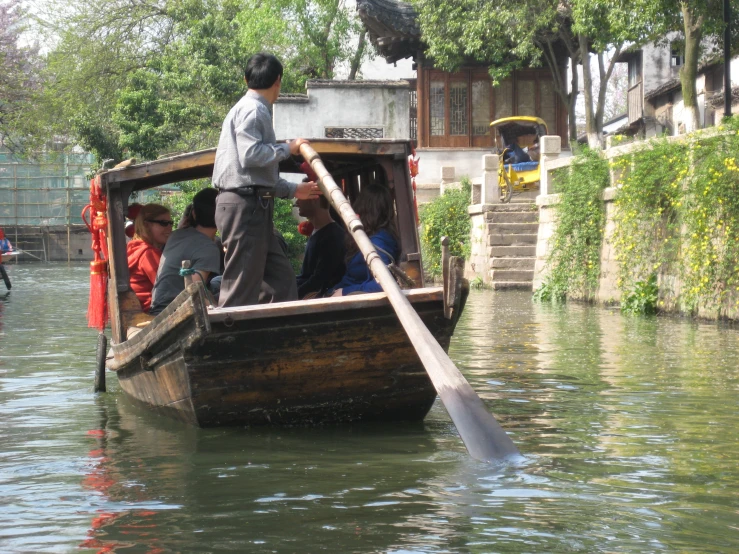 several people on a long boat in the water