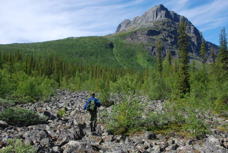 man trekking in a rocky mountain valley