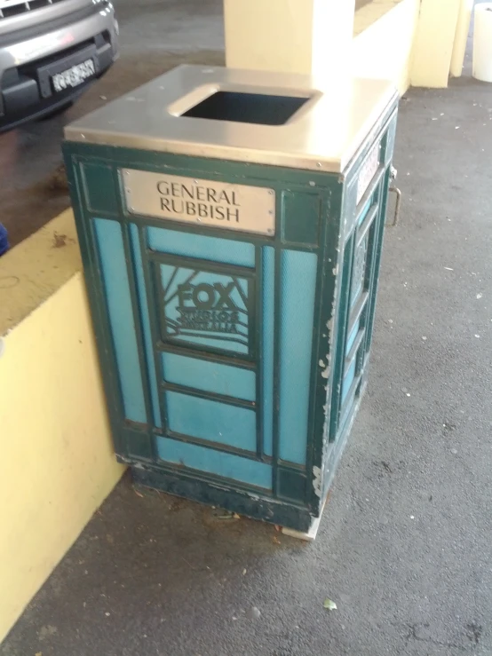 a garbage can sitting in front of some buildings