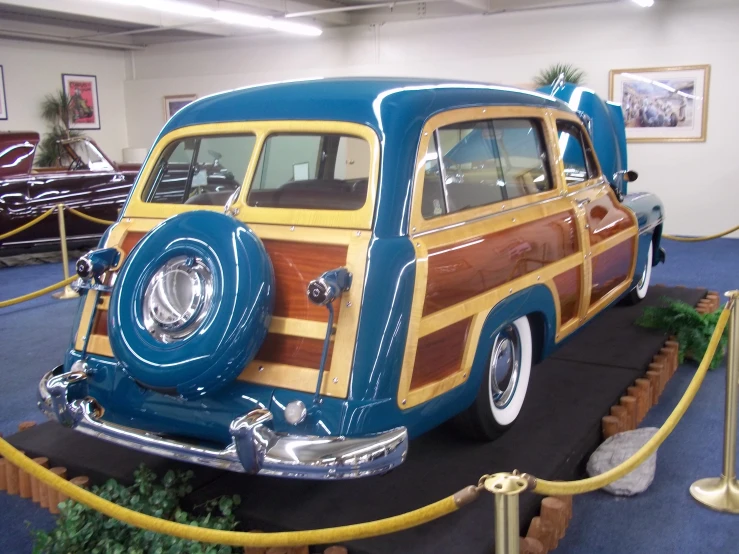 a very pretty blue car on display in a showroom