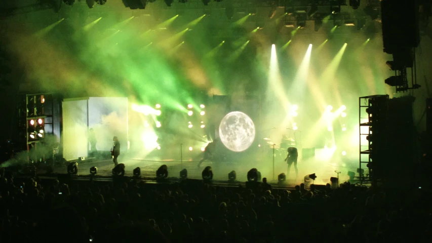 a person on stage in front of bright lights