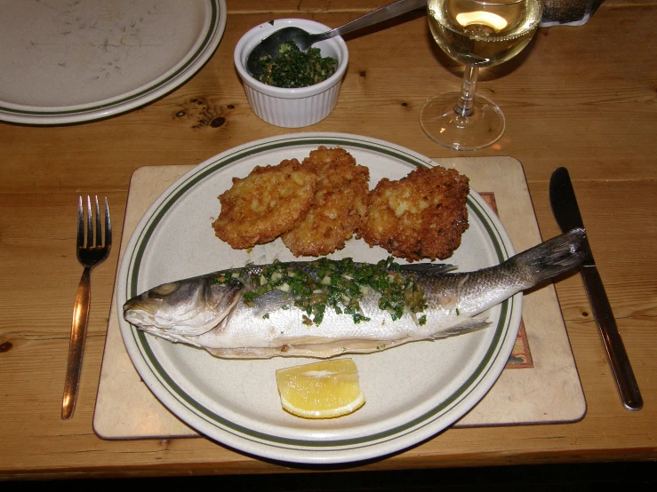 a fish and some bread are sitting on a plate