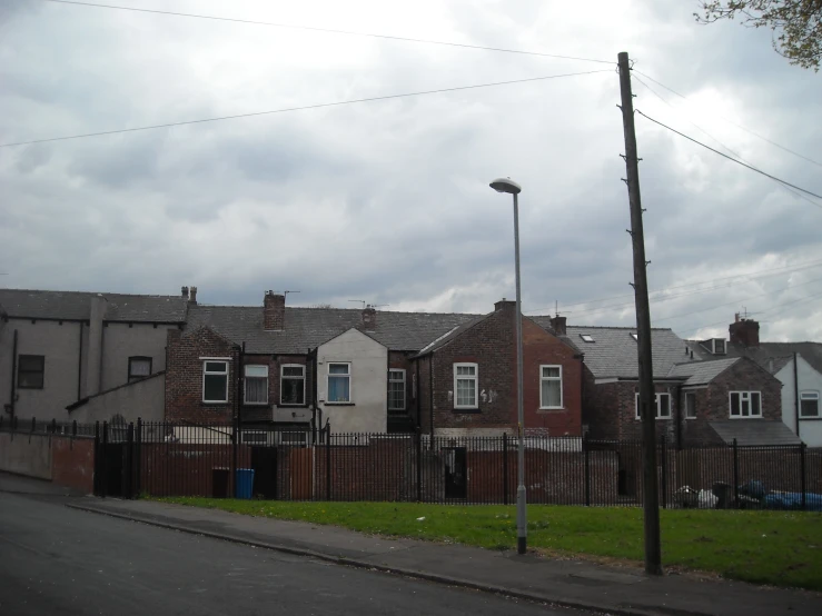 two big houses are located by a fence