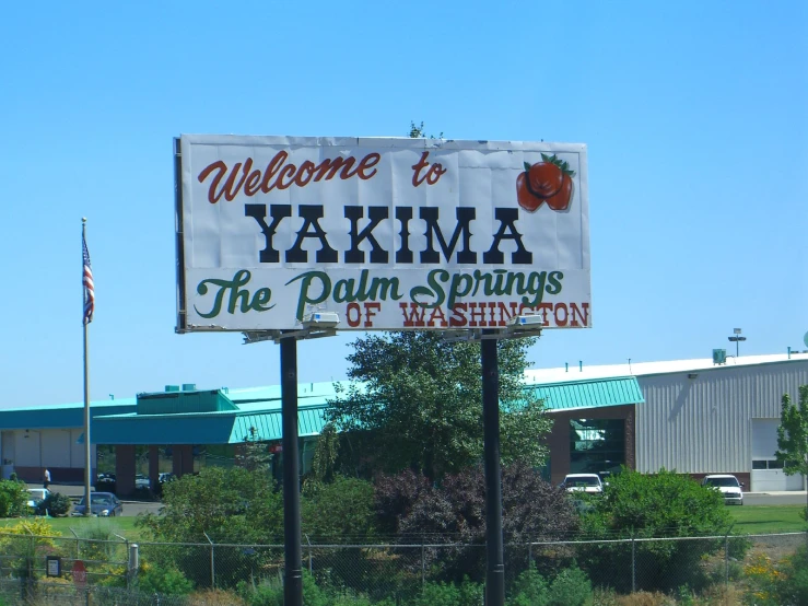 a large white sign with a name for yakim the palm springs