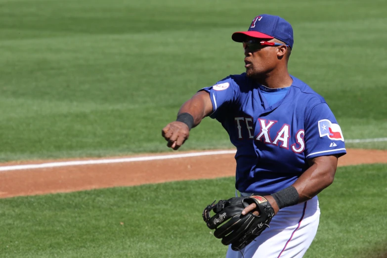 a baseball player throwing a baseball on a field