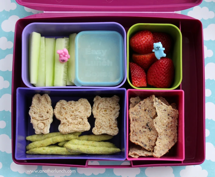 the food in a box contains sandwiches, fruits and veggies
