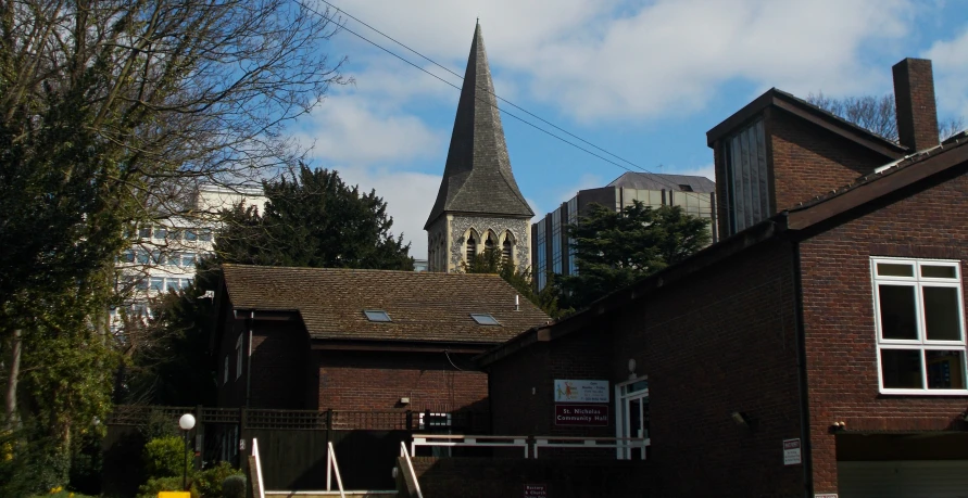 a brick building with a steeple in the middle