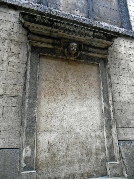 an old building with a window, some holes in the wall